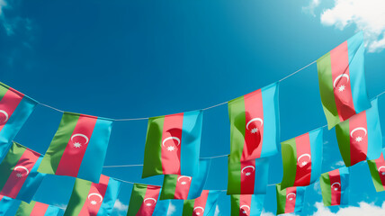 Flag of Azerbaijan against the sky, flags hanging vertically