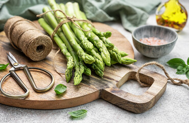 Bunch of raw asparagus stems with different spices