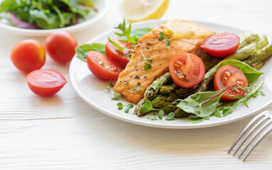 Baked Delicious salmon, green asparagus on  plate
