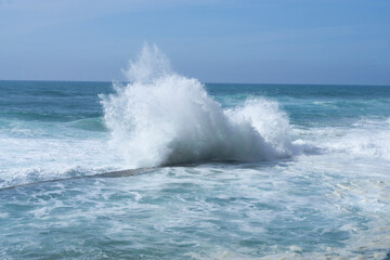 Waves in the ocean. Portugal coast ocean waves. Beautiful colour. Beautiful sea waves with foam of blue and turquoise color isolated on white background.