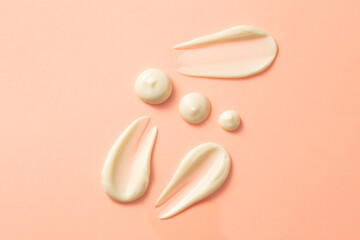 Creamy streaks on a pastel pink background. Special cream for moisturizer or mask products. Top...