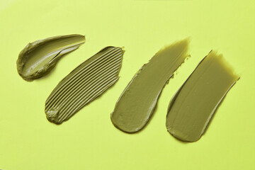 Top view of cream streaks have different shapes with the same texture of the mask. Scene for design banner and advertising cosmetics product with cream texture on pastel background.