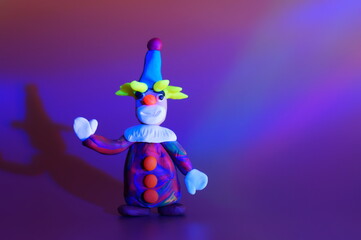 A toy clown on a bright colored background. Children's toys. A festive event. Celebration, fun.