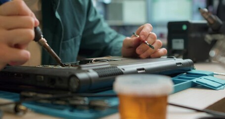 professional talented engineer repairs a laptop and motherboard with a soldering iron. Service center. Slow motion, guy works with a soldering iron. laptop charging cord repair