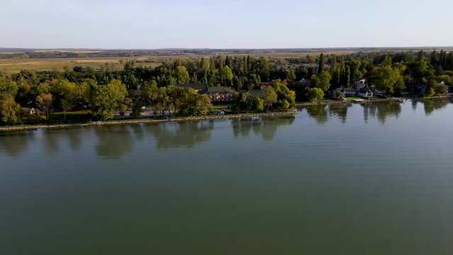 Luxury houses on shore of Lake Balaton in Fonyod, Hungary. Aerial over water.