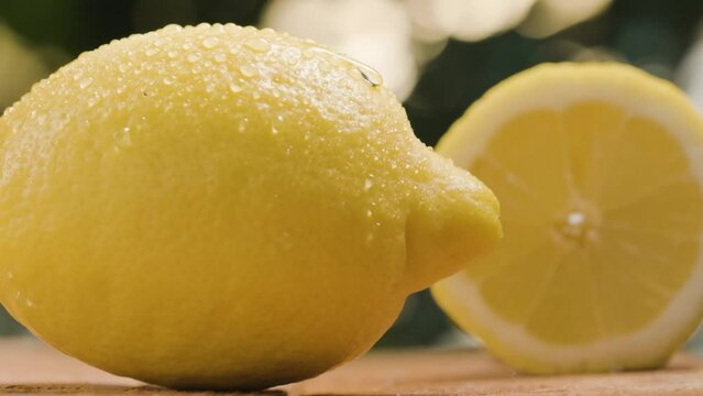 Extreme close-up of water drop flowing along fresh lemon in Slow motion