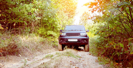 an SUV on a forest road overcomes off-road