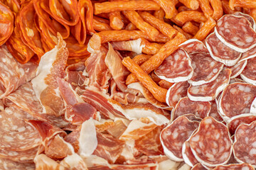 Homemade salami, chorizo and other cured sausages. Dried sausages cut into thin slices