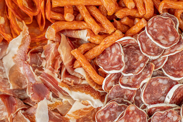 Homemade salami, chorizo and other cured sausages. Dried sausages cut into thin slices