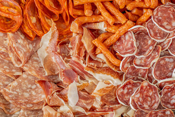 Homemade salami, chorizo and other cured sausages. Dried sausages cut into thin slices