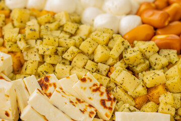 Cheese snacks in one container. Sliced cheese in different shapes. Cheese board for the celebration