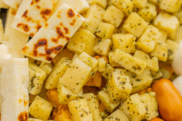 Cheese snacks in one container. Sliced cheese in different shapes. Cheese board for the celebration
