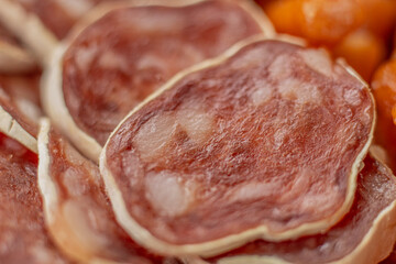 Homemade salami, chorizo and other cured sausages. Dried sausages cut into thin slices