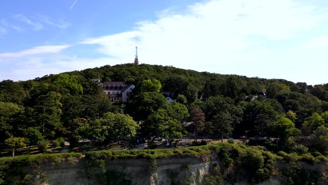 Luxury buildings among trees on bluff over Lake Balaton, Fonyod, Hungary, aerial.