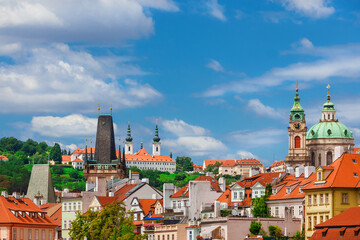 Mala Strana old district skyline with St Nicholas Church baroque dome, Strahov Monastery twin belfries and Bridge Tower in Prague