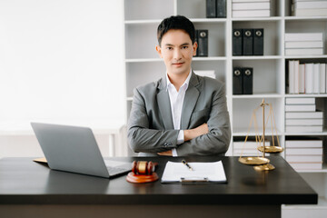 justice and law concept .Asian Male judge in a courtroom on table and Counselor working in office.