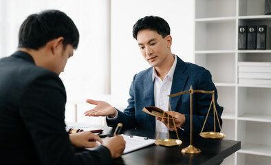 Asian business team and lawyers discussing contract papers sitting at the table. Concepts of law, advice, legal services. at office