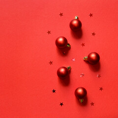 New Year's card. Christmas toys red balls and red shiny stars. Flat lay with copy space. christmas holiday background. Square.