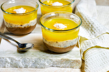Homemade layered vegan dessert of baked coconut cream and chocolate marble stone board with milk bottle