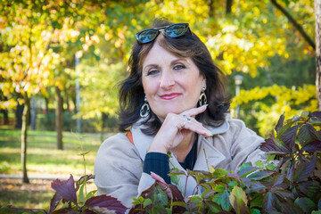 Smiling young woman in autumn park