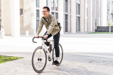 The guy with the business bag uses environmentally friendly transport. A young man riding a bicycle...