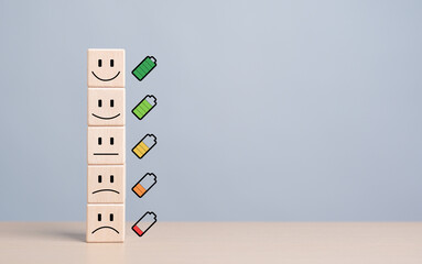 Mentality happiness care. Emotion face symbol on stacked wooden blocks with full to empty battery...