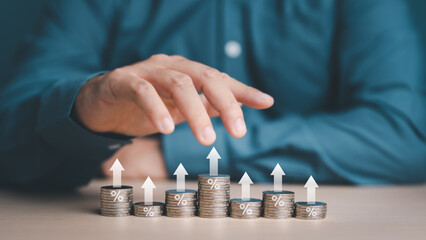 Investor, Trader or Businessman hand control stacking coins at different heights with percentage...