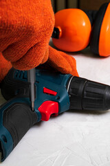 A mechanic changes switches for an electric drill after a long time of use. Repair of electrical...