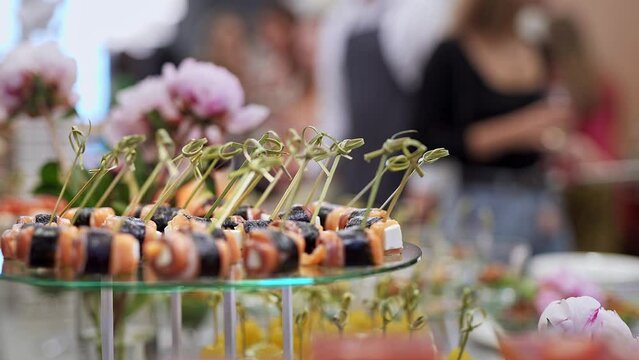 Richly served table with delicious snacks. Business event with a free buffet, delicious and gourmet sandwiches, canap s and bruschettas for visitors.