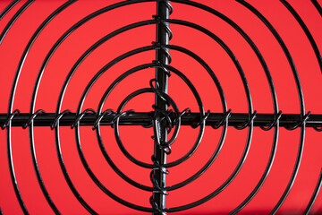 Steel spiral and cross against red background