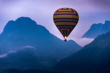 Hot air Balloon float over Misty Mountain in Vang Vieng, Laos