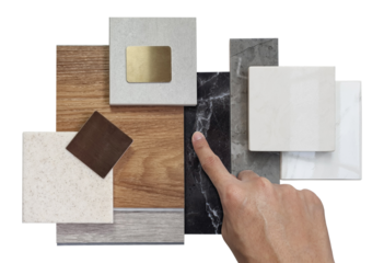 interior designer chooses luxury sample materials including black and gery marble stones, wooden vinyl flooring tiles, grainy quartz, ceramic tiles isolated on background with clipping path.