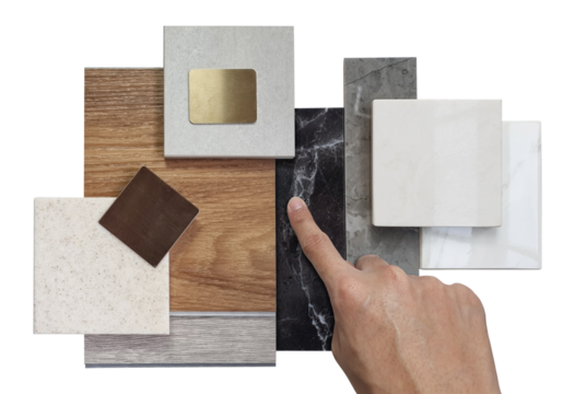 interior designer chooses luxury sample materials including black and gery marble stones, wooden vinyl flooring tiles, grainy quartz, ceramic tiles isolated on background with clipping path.