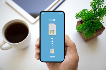 male hands holding phone with Sim card replacement on eSim