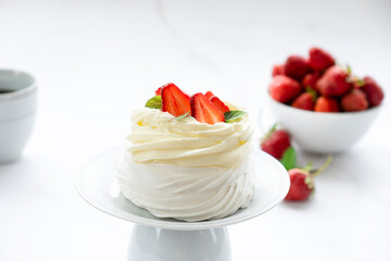 Meringues Pavlova cake with fresh strawberry and mascarpone cream. Recipe of traditional dessert Anna Pavlova. Homemade bakery.