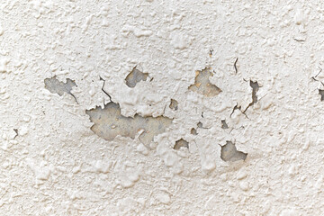 Peeling stucco painted concrete wall. Leaking rain cause the wall  cracked. Water damaged the wall. 