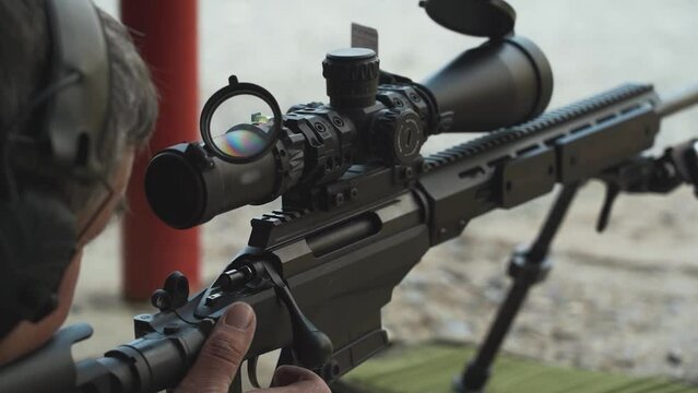 the sniper aims, shoots and then reloads the rifle