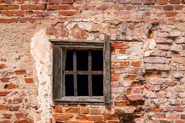 Fototapeta na wymiar Old red brick castle wall and old window