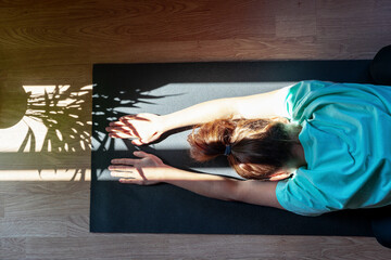 High angle view photo of female person doing yoga exercise on yoga mat