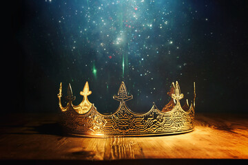 low key image of beautiful queen or king crown over wooden table. vintage filtered. fantasy medieval period - obrazy, fototapety, plakaty