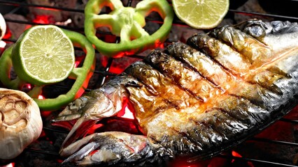 Fiery Catch: Close-up View of Freshly Grilled Trout Fish by the Campfire