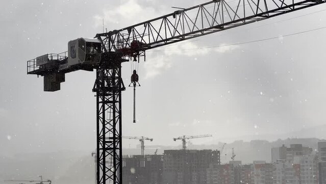 Rain at a construction site with a tower crane in the background