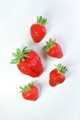 Red strawberries isolated on white background with shadows, , top view. Summer sweet fruits and berries