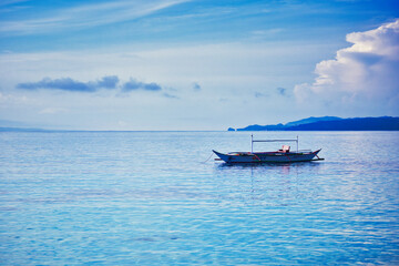 Obraz premium fisherman on small boat on the sea
