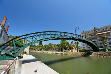 Fototapeta premium France, Montargis. Cityscape with a canal. May 29, 2023.