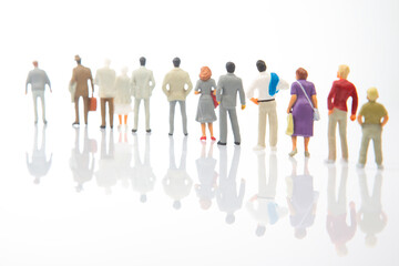 miniature people. blurry images of people on a white background. Loneliness and family acceptance in human society.