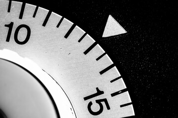 monochrome close-up of an old analog laboratory timer set to 13
