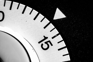 monochrome close-up of an old analog laboratory timer set to 14