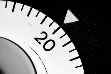 monochrome close-up of an old analog laboratory timer set to 20
