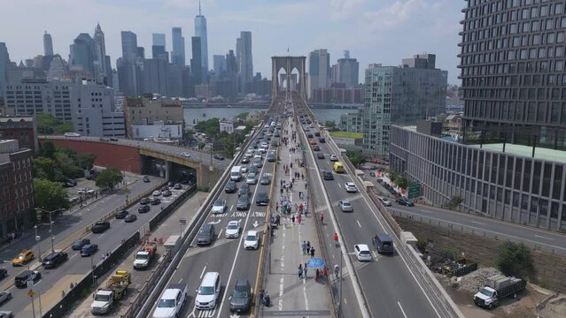 flying over pedestrian, bike and car lanes towards Brooklyn Bridge